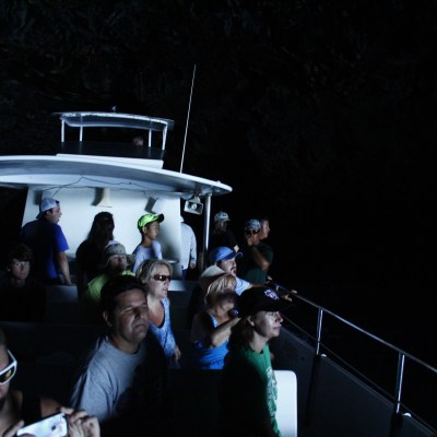 People onlooking as the boat exits a cave