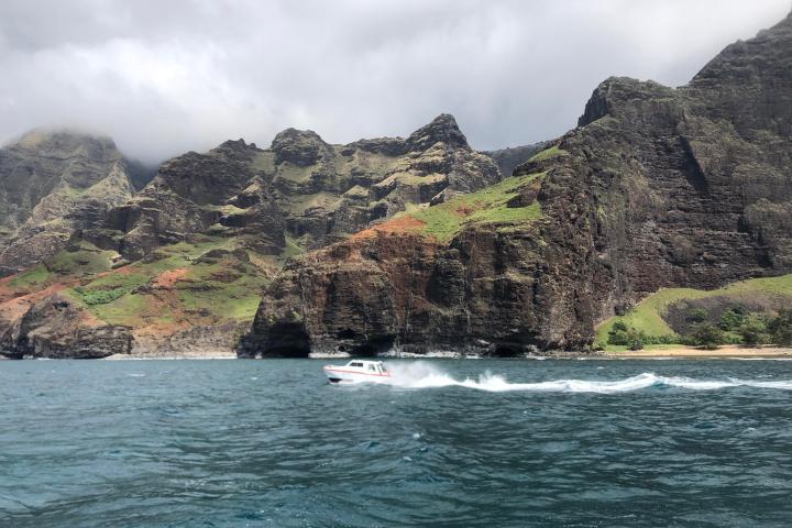 a large body of water with a mountain in the background